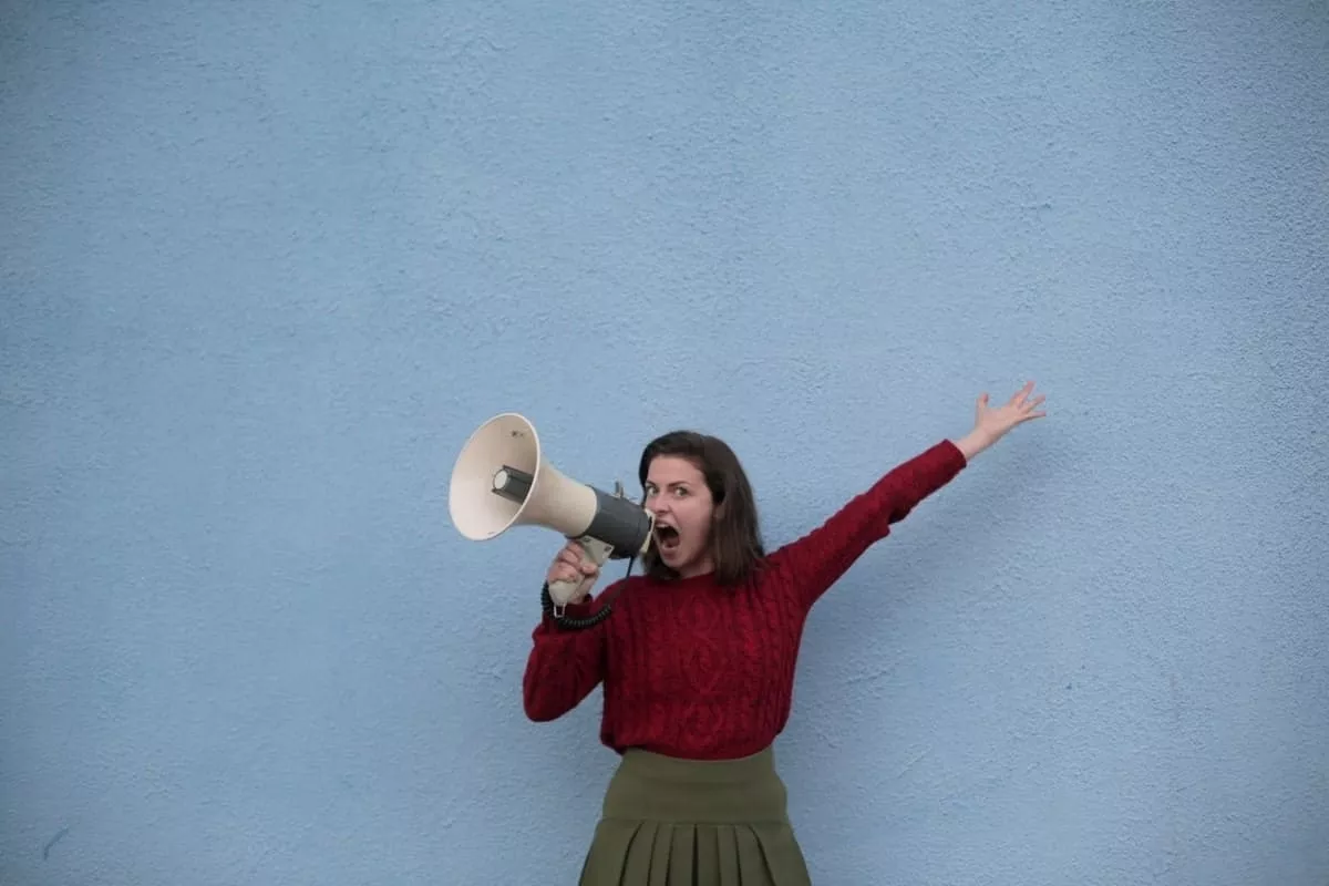 woman shouting into speaker phone