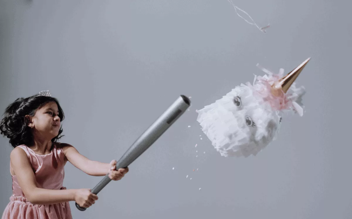 girl hitting a pinata with baseball bat